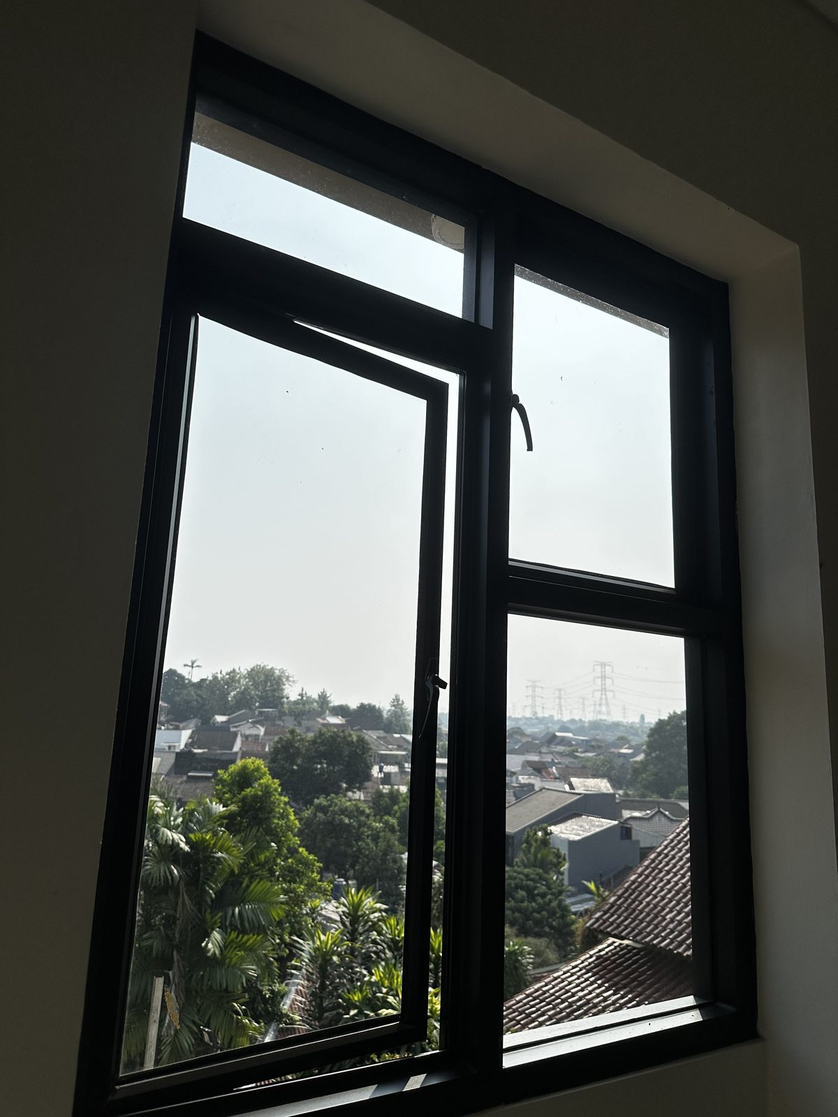 Pemandangan perbukitan dari jendela unit
